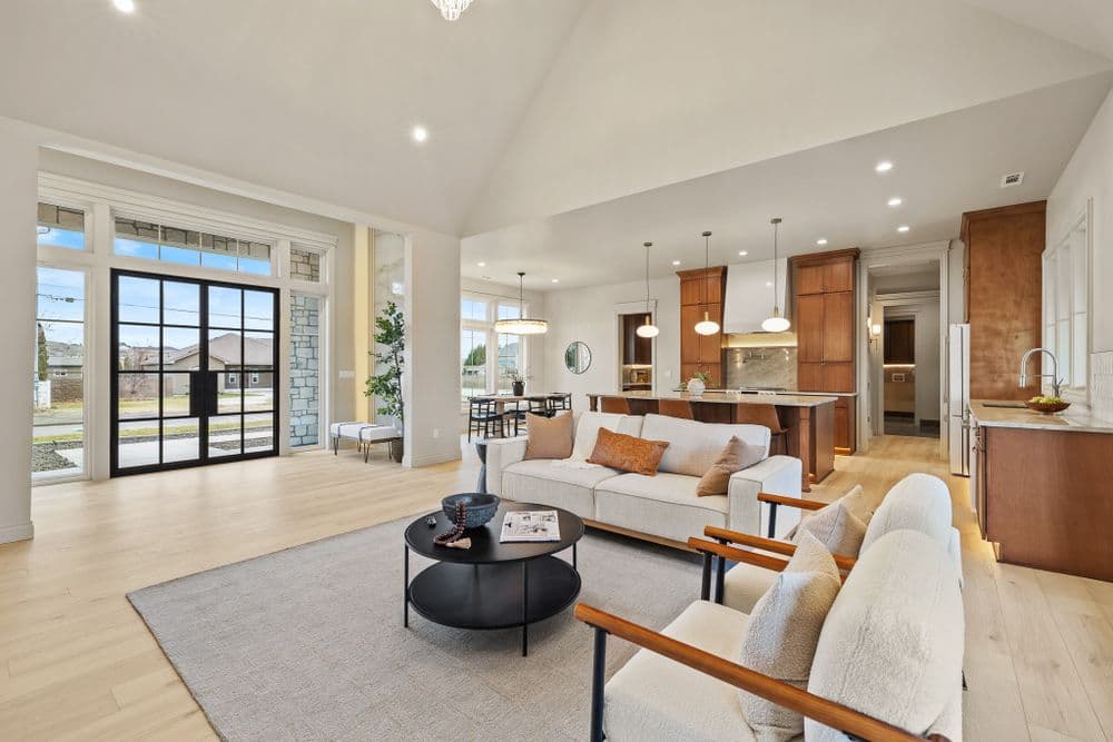 Modern open-concept living room with stylish furniture, natural light, and elegant wooden accents.
