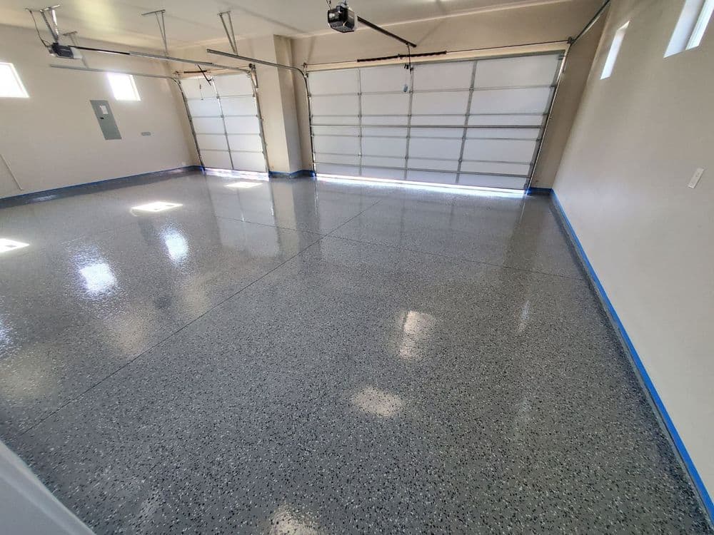 Spacious garage with polished epoxy floor and natural light from windows.