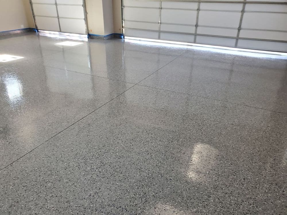 Shiny epoxy garage floor with light reflections and smooth finish, perfect for home improvement.
